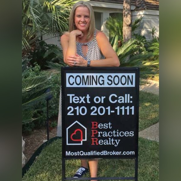 Leah McNamara with her Best Practices Realty Coming Soon sign